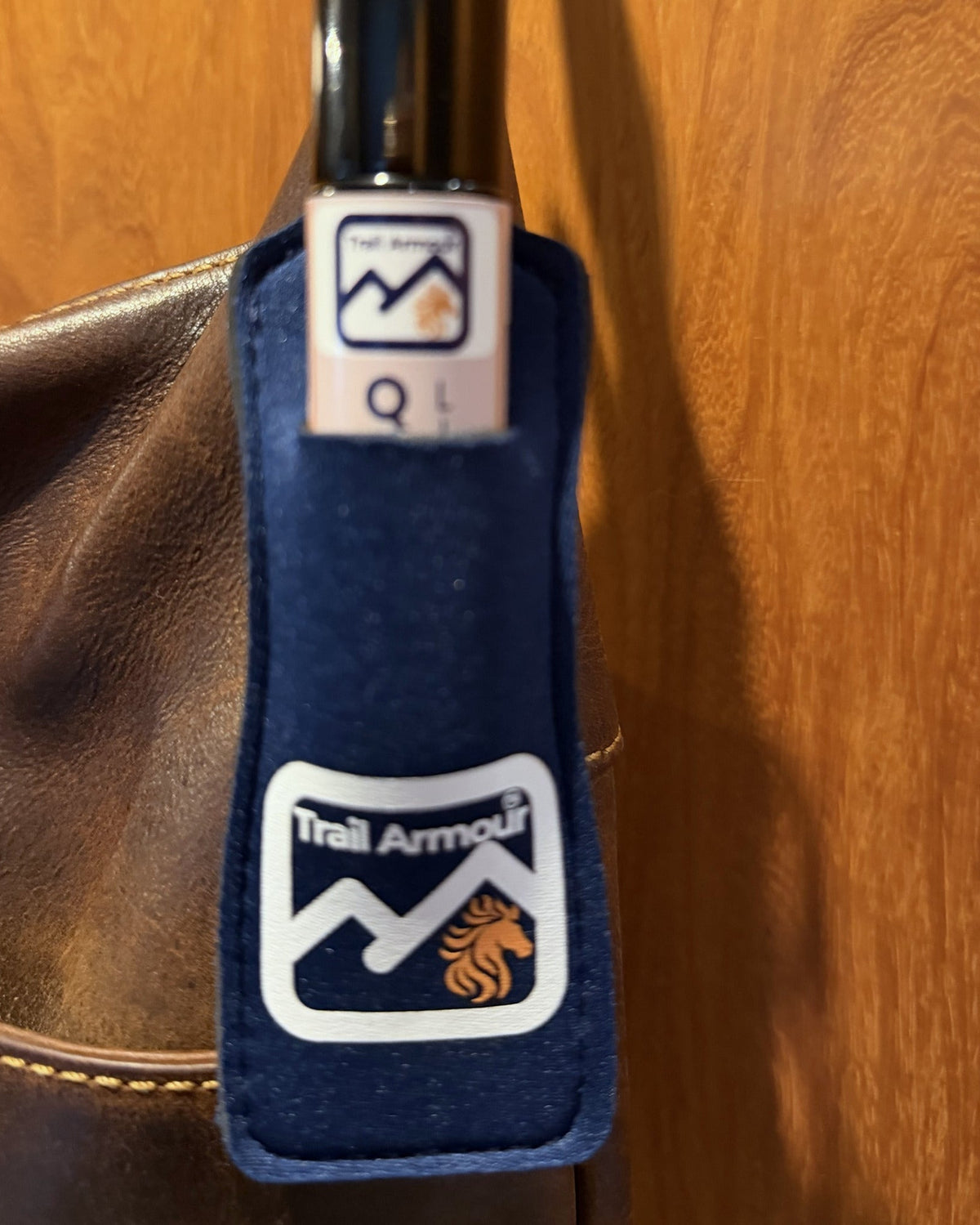 Close up of a Trail Armour QUENCH roller in a navy neoprene lip balm holder