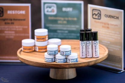Trail Armour RESTORE, BUFF and QUENCH displayed on a wooden stand